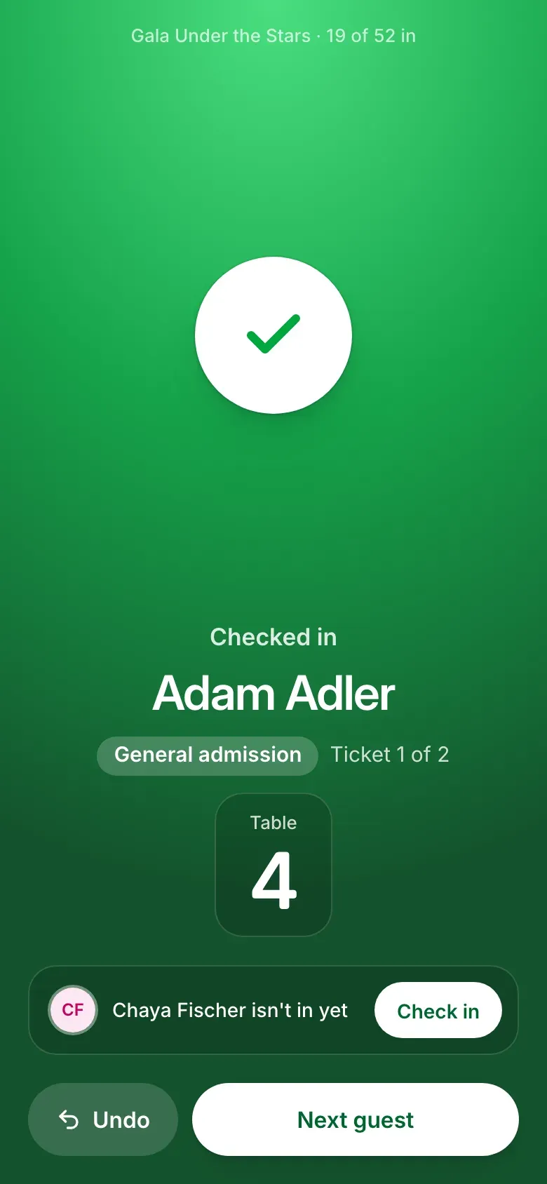 Check-in on a phone after a scan: Checked in, the guest’s name, their ticket and table number, and a button to check in the rest of the party.